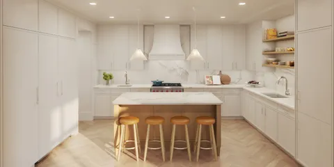 a kitchen with stainless steel appliances kitchen island granite countertop a sink and a refrigerator