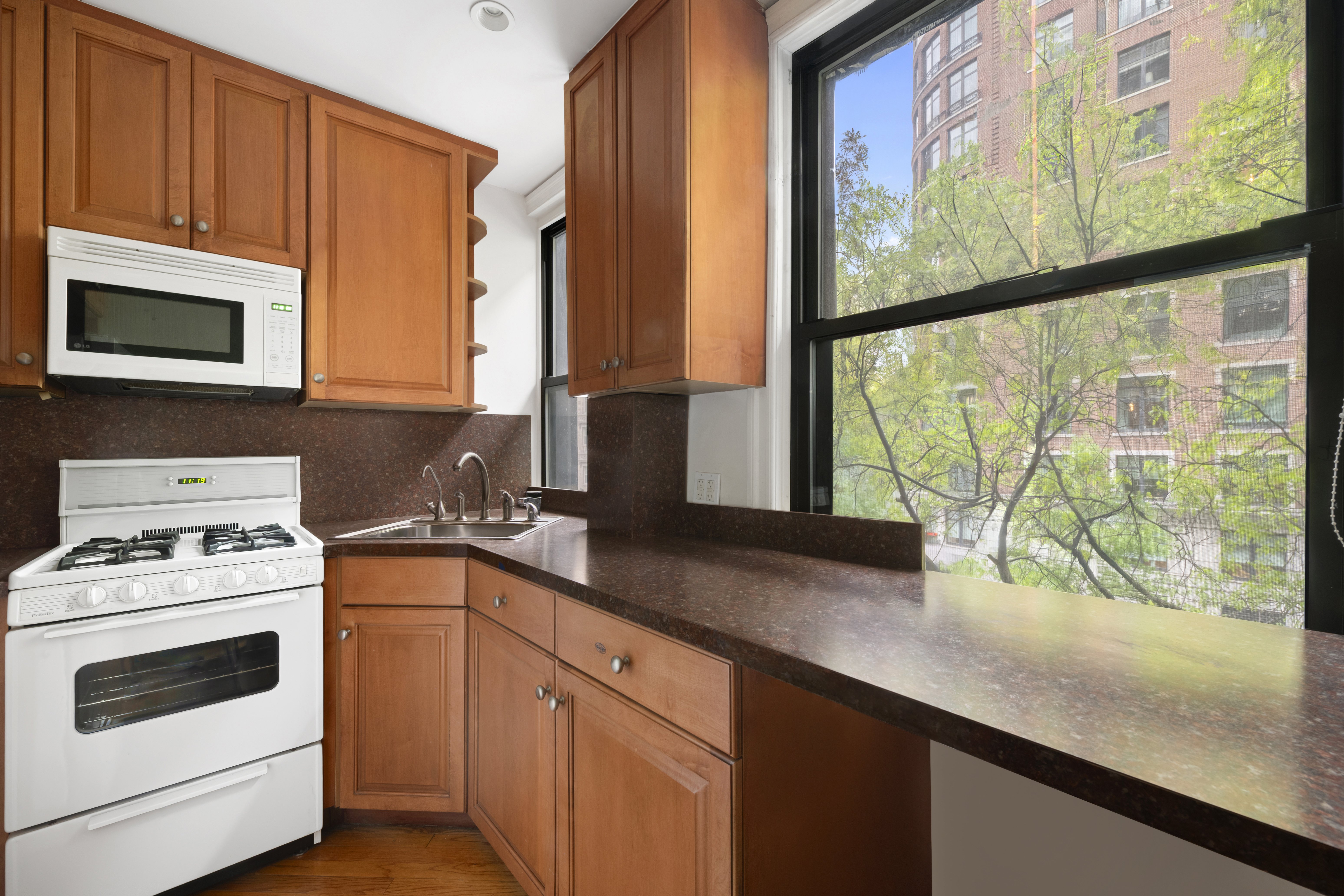 545 West End Avenue, Unit 4B Manhattan, NY 10024 - Photo 4 of 8 a kitchen with appliances cabinets and a sink