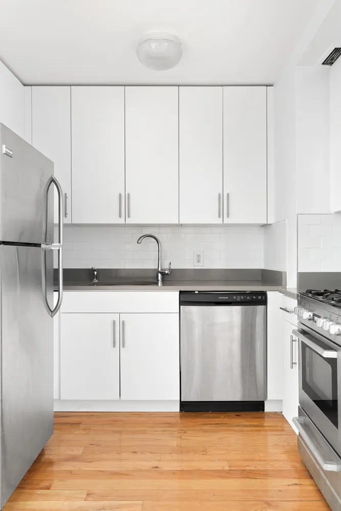 a kitchen with a white cabinets and white appliances