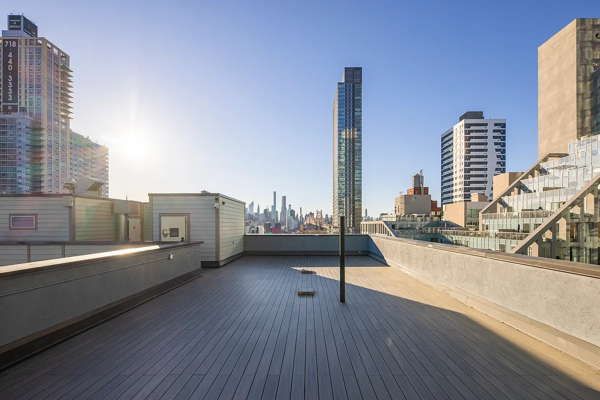 51-42 27th Street, Unit 6C Queens, NY 11101 - Photo 9 of 10 a view of roof deck with tall buildings