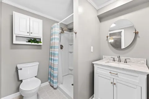 a bedroom with a bed and a large mirror