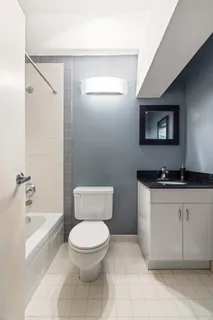 a bathroom with a toilet a sink and bathtub