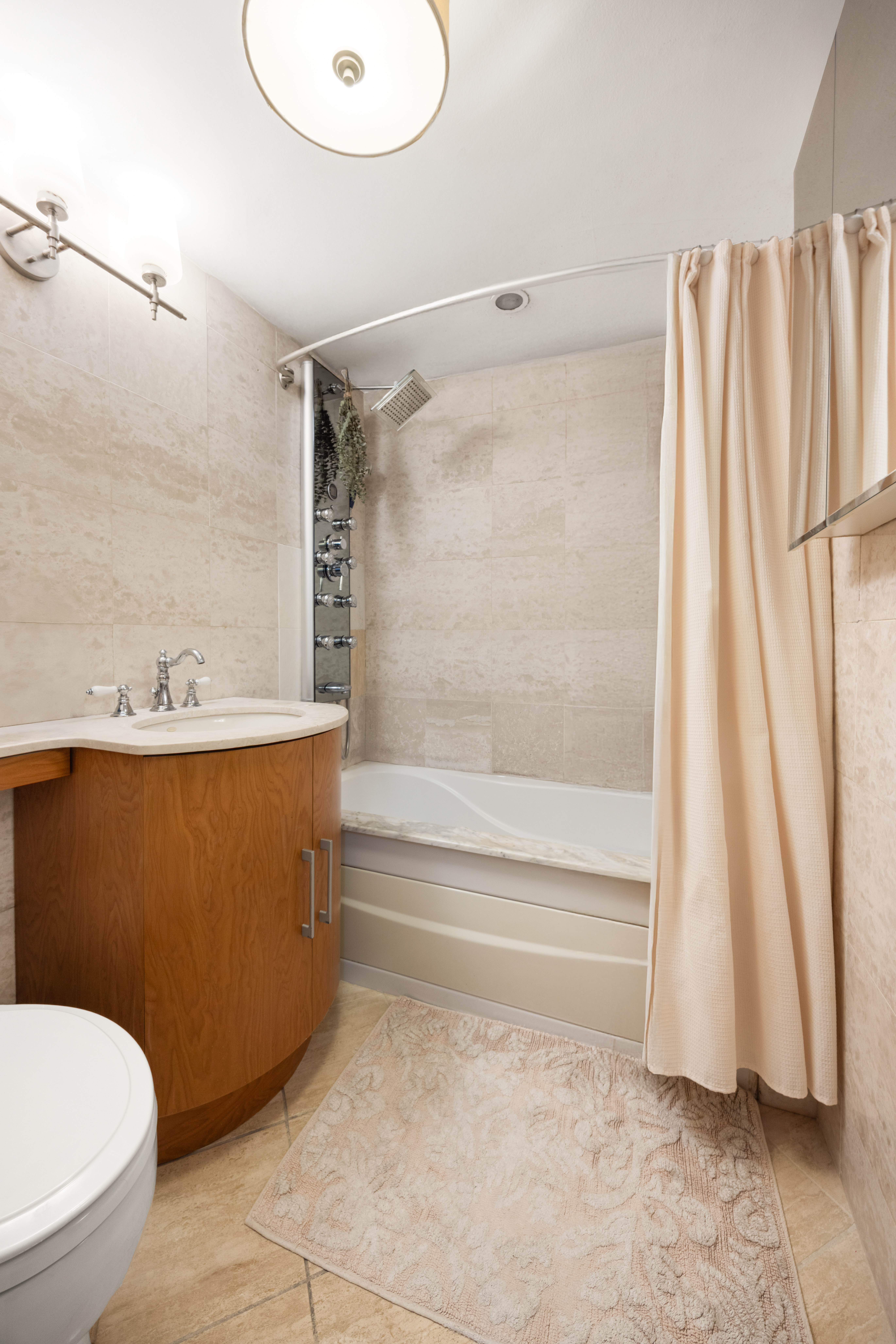 136 East 56th Street, Unit 10JK Manhattan, NY 10022 - Photo 5 of 12 a bathroom with a sink toilet and shower