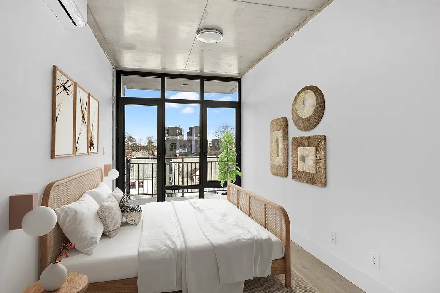 a bedroom with a large bed and a large window