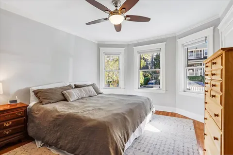 a bedroom with a bed and a large window