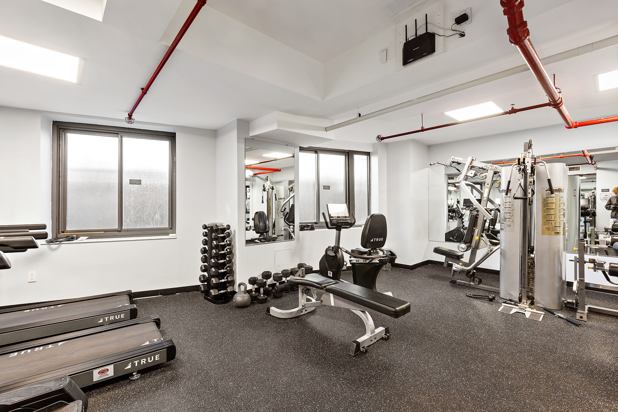 45 East End Avenue, Unit 6/7B Manhattan, NY 10028 - Photo 15 of 17 a room with gym equipment and mirrors
