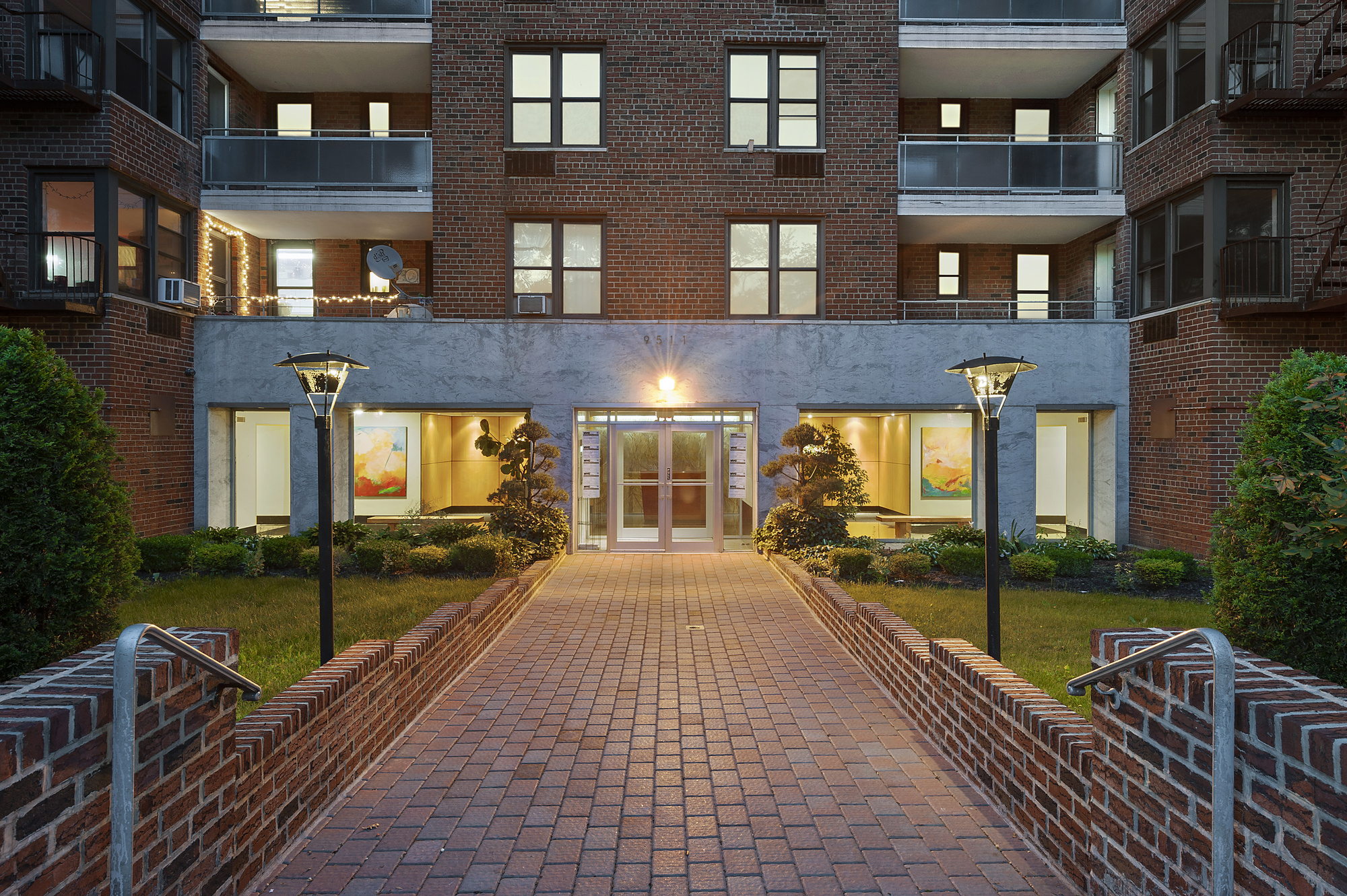 9511 Shore Road, Unit 606 Brooklyn, NY 11209 - Photo 10 of 17 a view of a brick building next to a yard