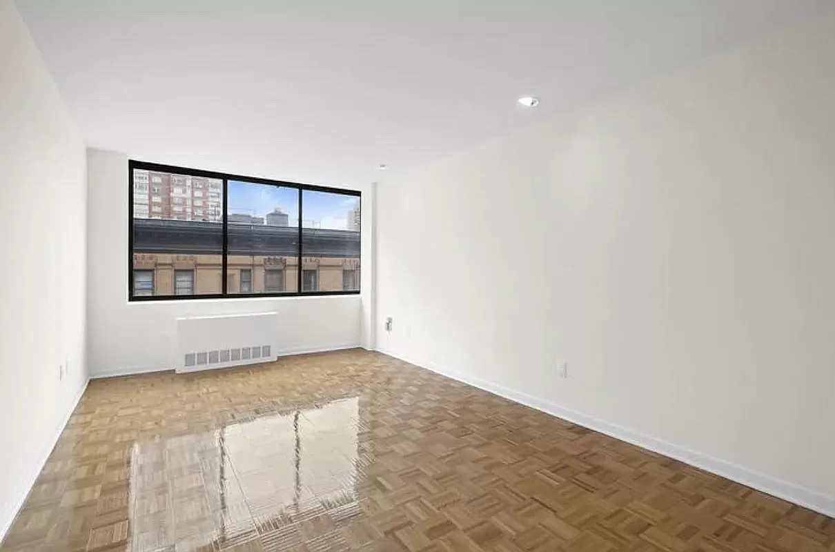 300 East 90th Street, Unit 6D Manhattan, NY 10128 - Photo 4 of 7 a view of an empty room with a window
