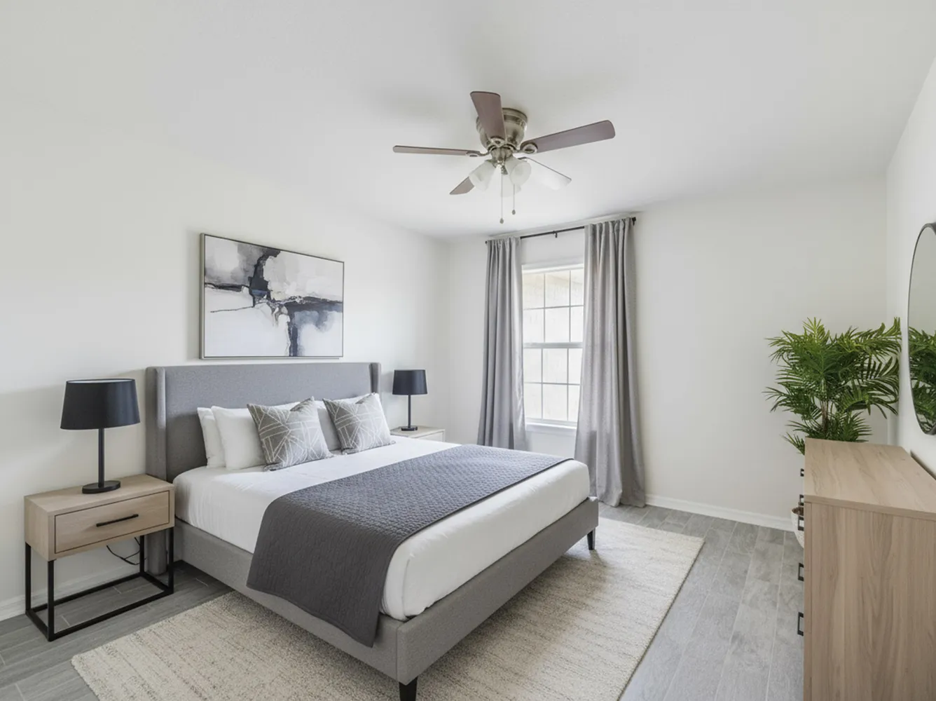 a bedroom with a large bed and potted plant