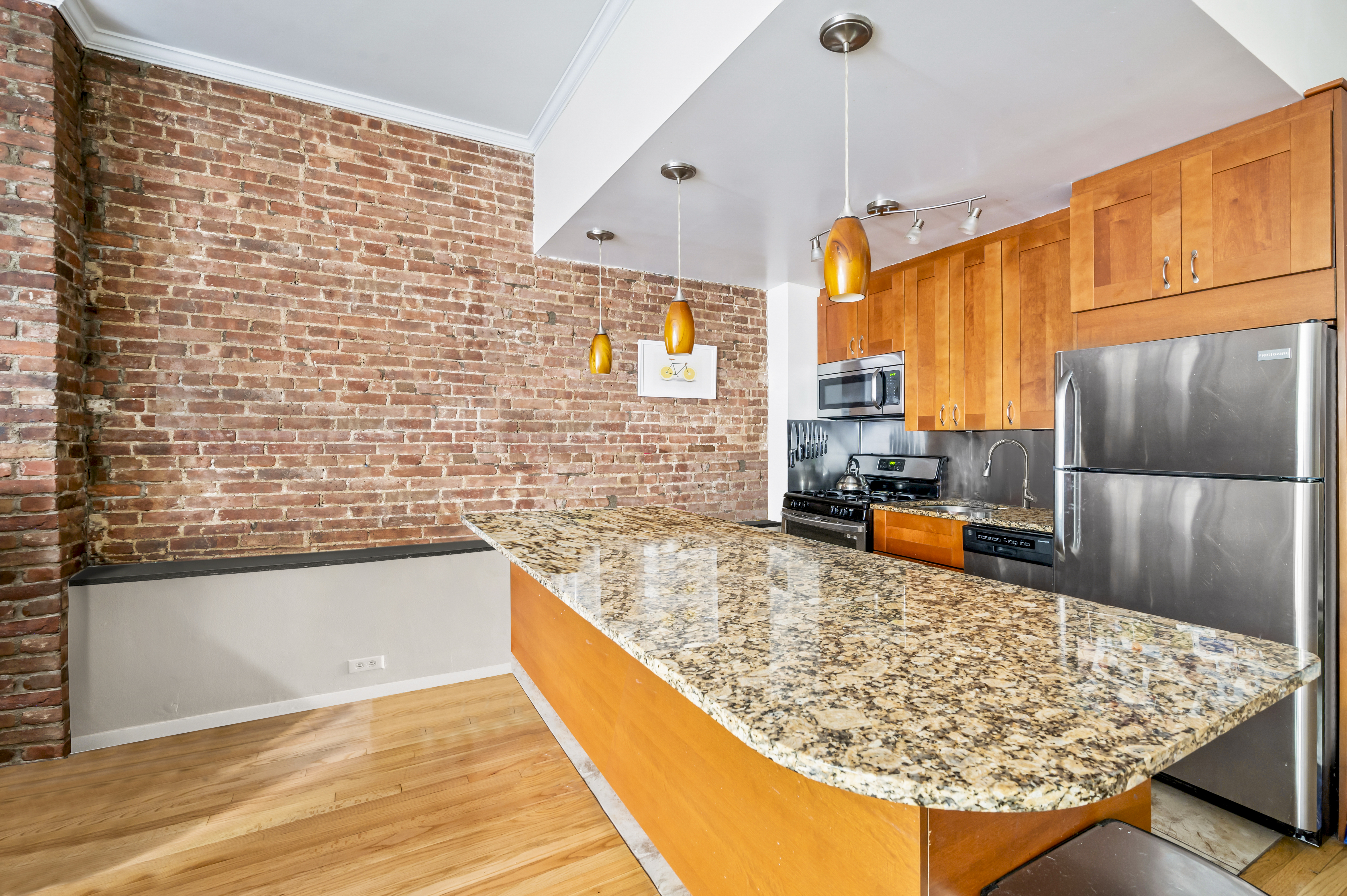53 West 94th Street Manhattan, NY 10025 - Photo 2 of 12 a kitchen with stainless steel appliances granite countertop a sink stove and refrigerator