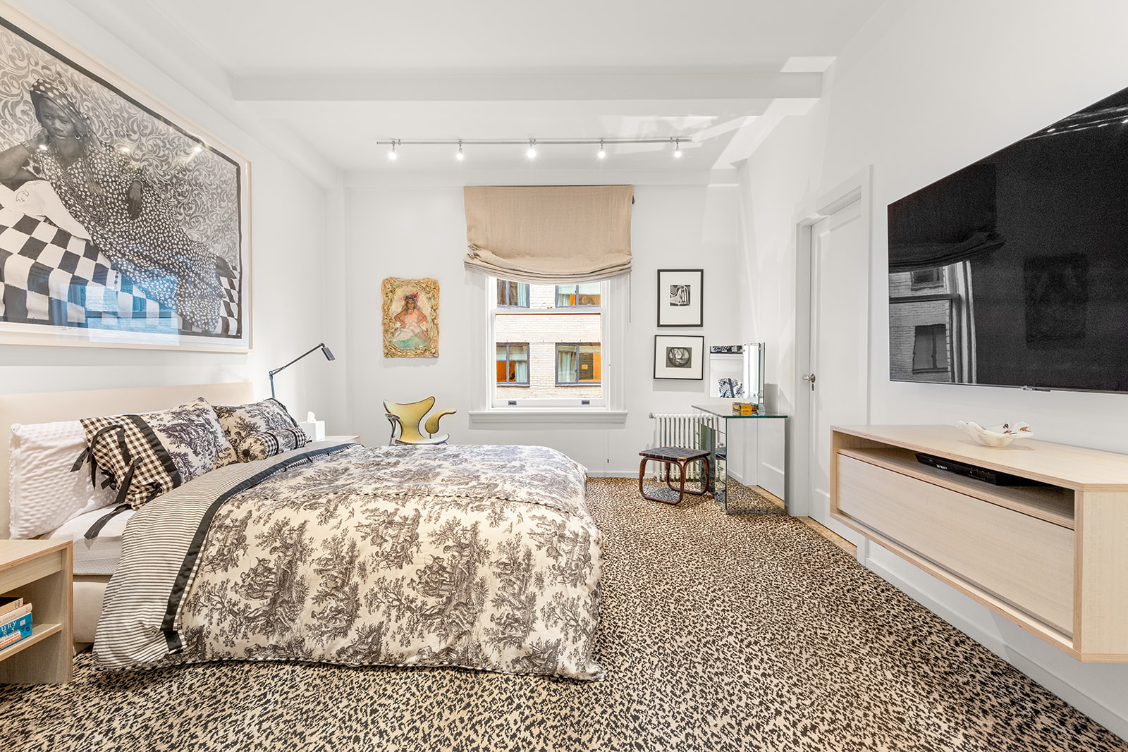 40 East 62nd Street, Unit 6E Manhattan, NY 10065 - Photo 15 of 25 a bedroom with a bed and a flat screen tv