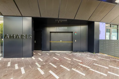 a roof deck with couches and potted plants