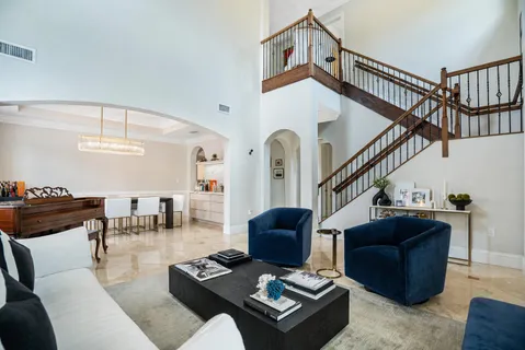 a living room with furniture and a ceiling fan