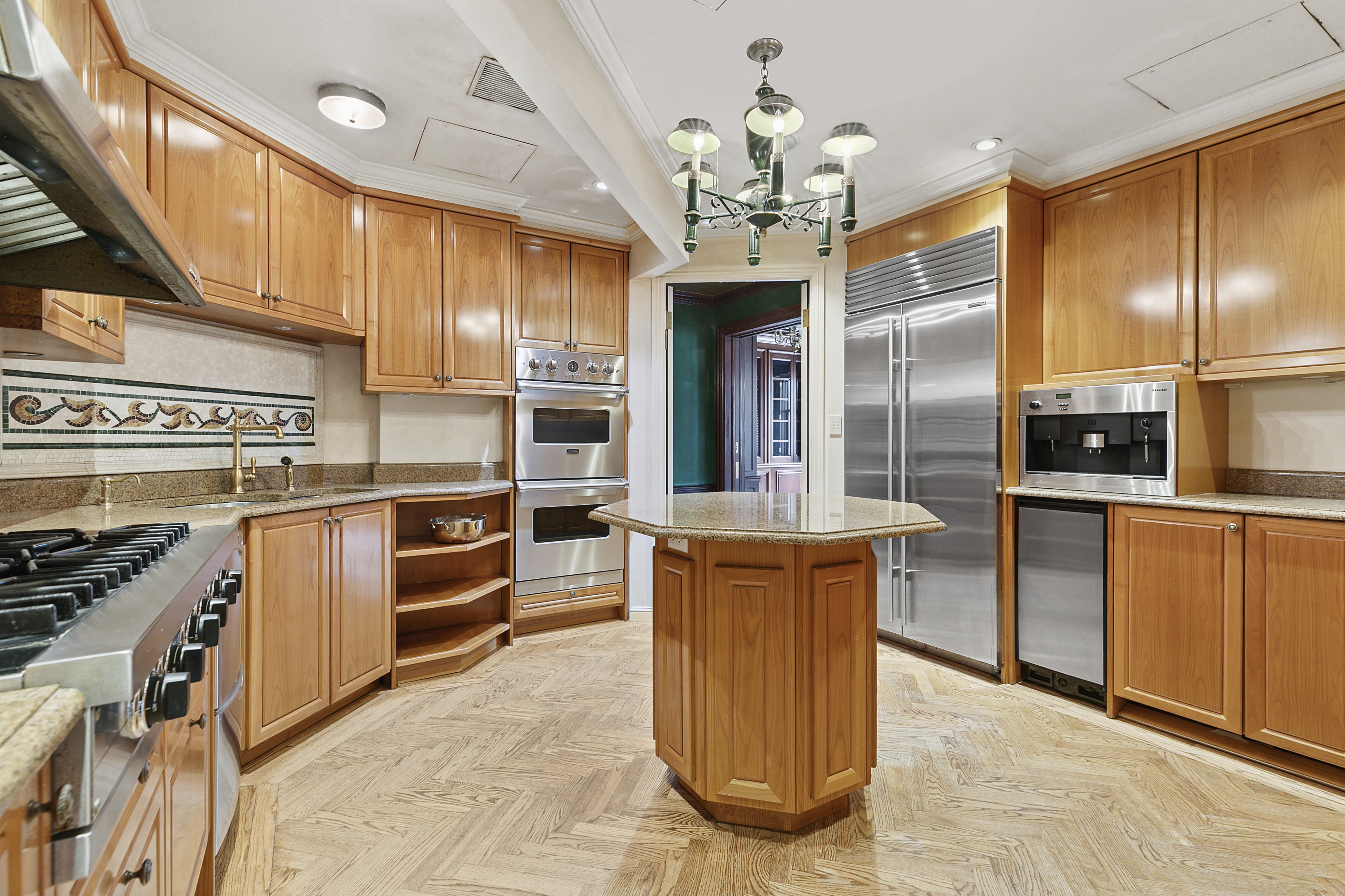 781 5th Avenue Manhattan, NY 10022 - Photo 12 of 18 a kitchen with stainless steel appliances granite countertop a sink and cabinets