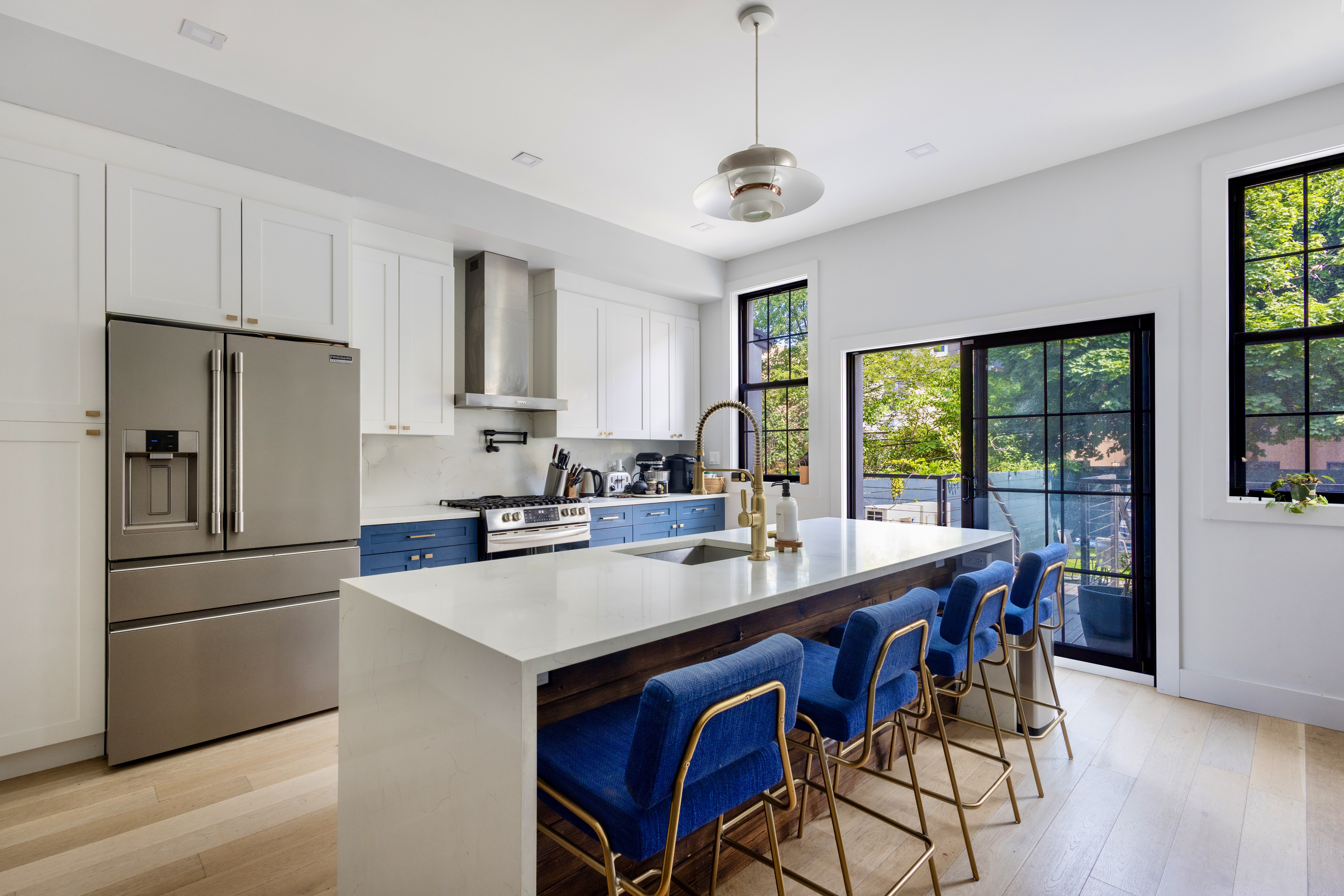 239 Winthrop Street Brooklyn, NY 11225 - Photo 6 of 20 a kitchen with stainless steel appliances granite countertop a stove a refrigerator a sink a dining table and chairs with wooden floor
