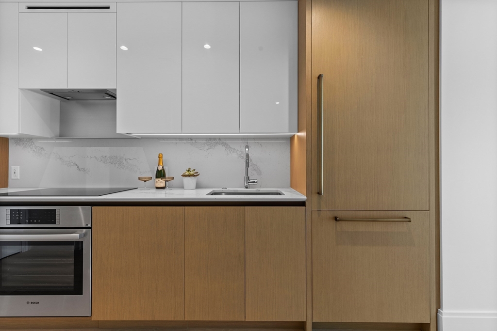 380 Harrison Avenue, Unit 1005 Boston, MA 02118 - Photo 2 of 14 a kitchen with stainless steel appliances granite countertop a sink and a refrigerator