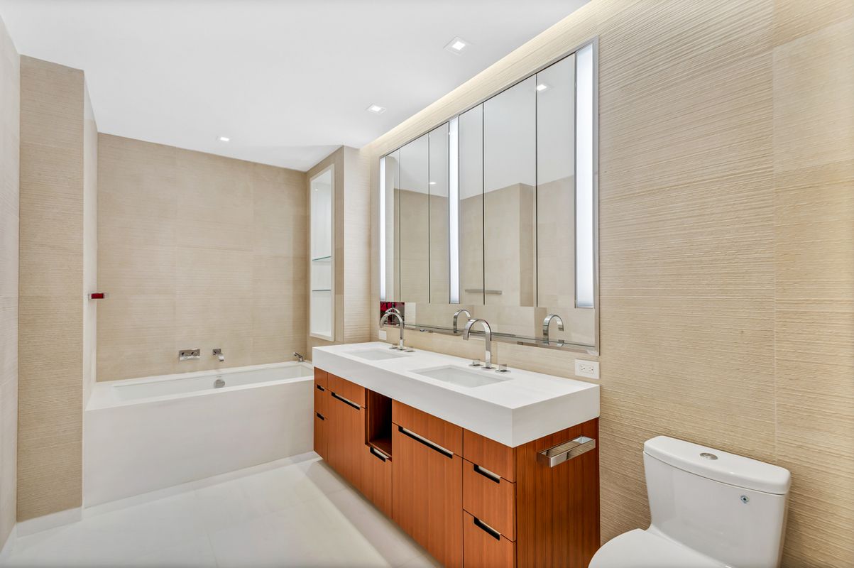 1 West End Avenue, Unit 27D Manhattan, NY 10023 - Photo 6 of 21 a bathroom with a sink a toilet and a bathtub