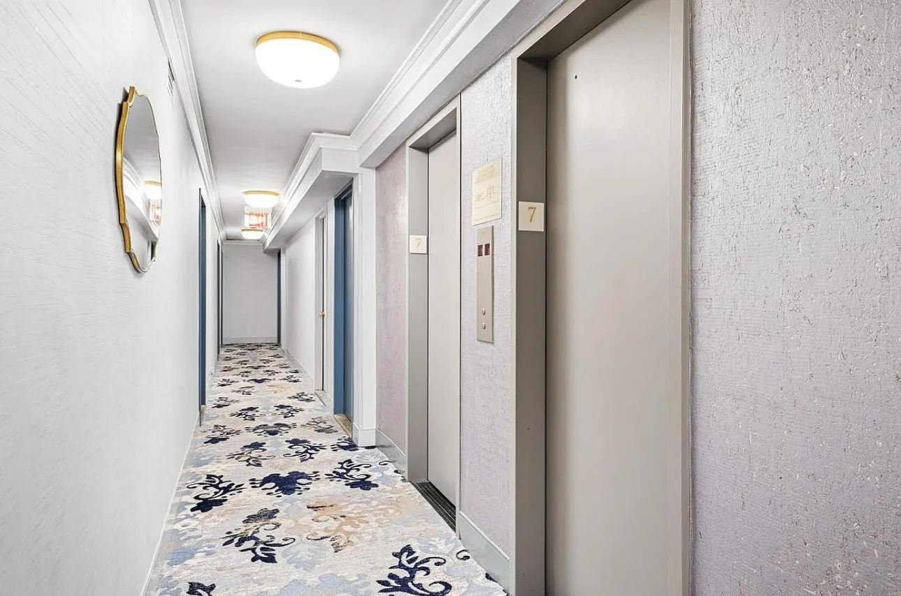 a view of a hallway with wooden floor and entryway