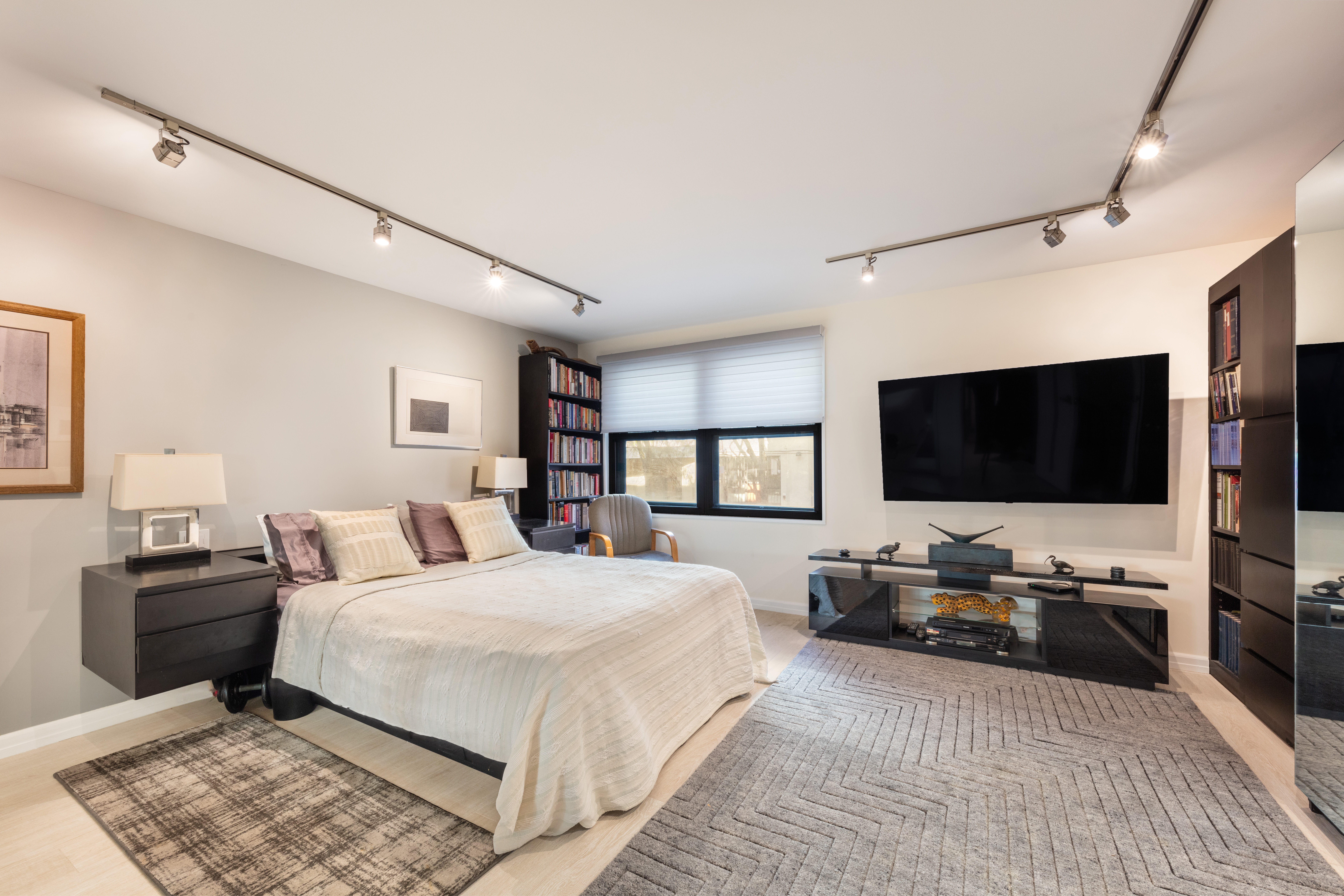 129 Barrow Street, Unit GA Manhattan, NY 10014 - Photo 11 of 17 a bedroom with a bed and a flat screen tv