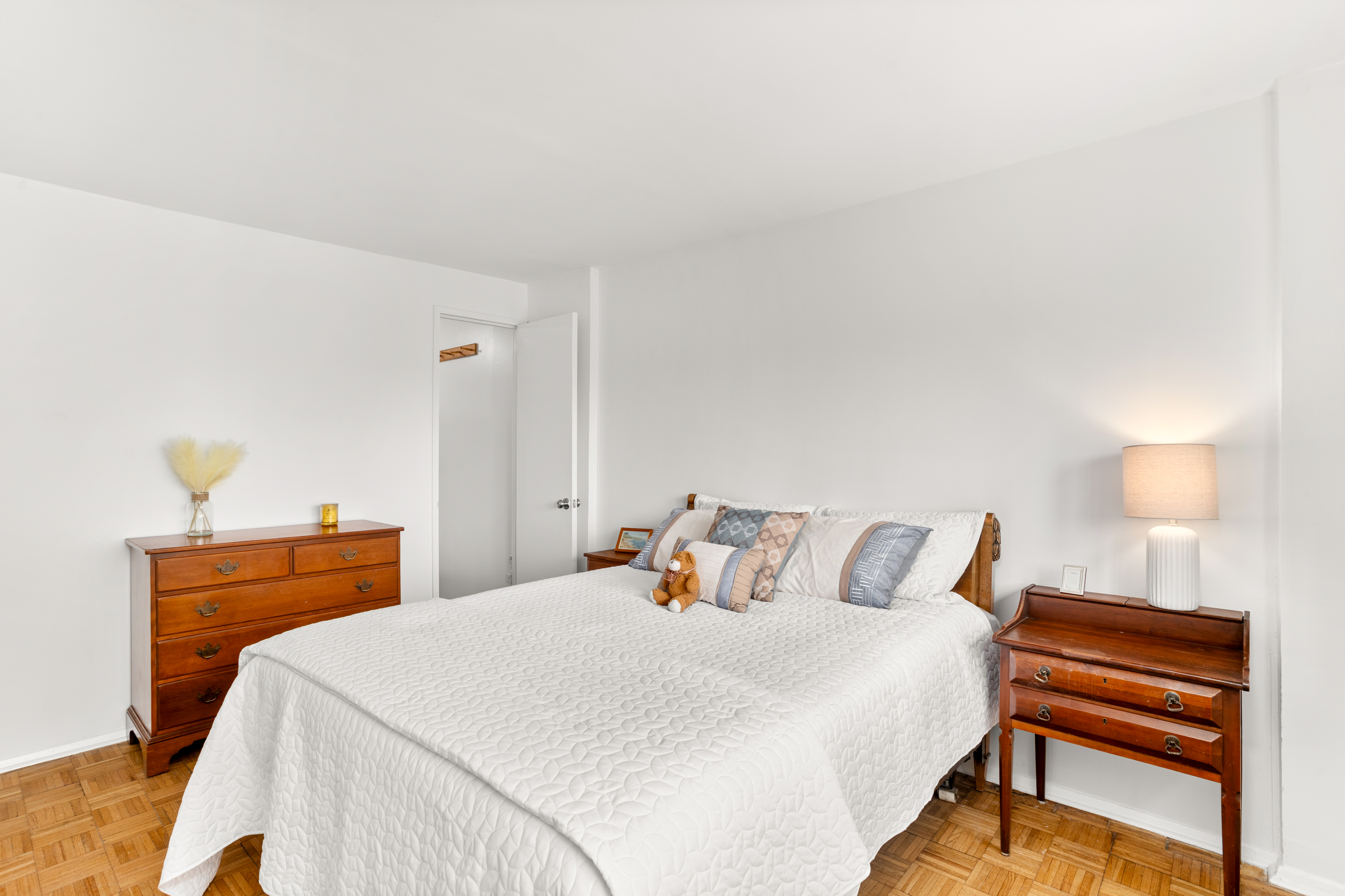 609 Columbus Avenue, Unit 14E Manhattan, NY 10024 - Photo 17 of 24 a bedroom with a bed and a lamp on dresser