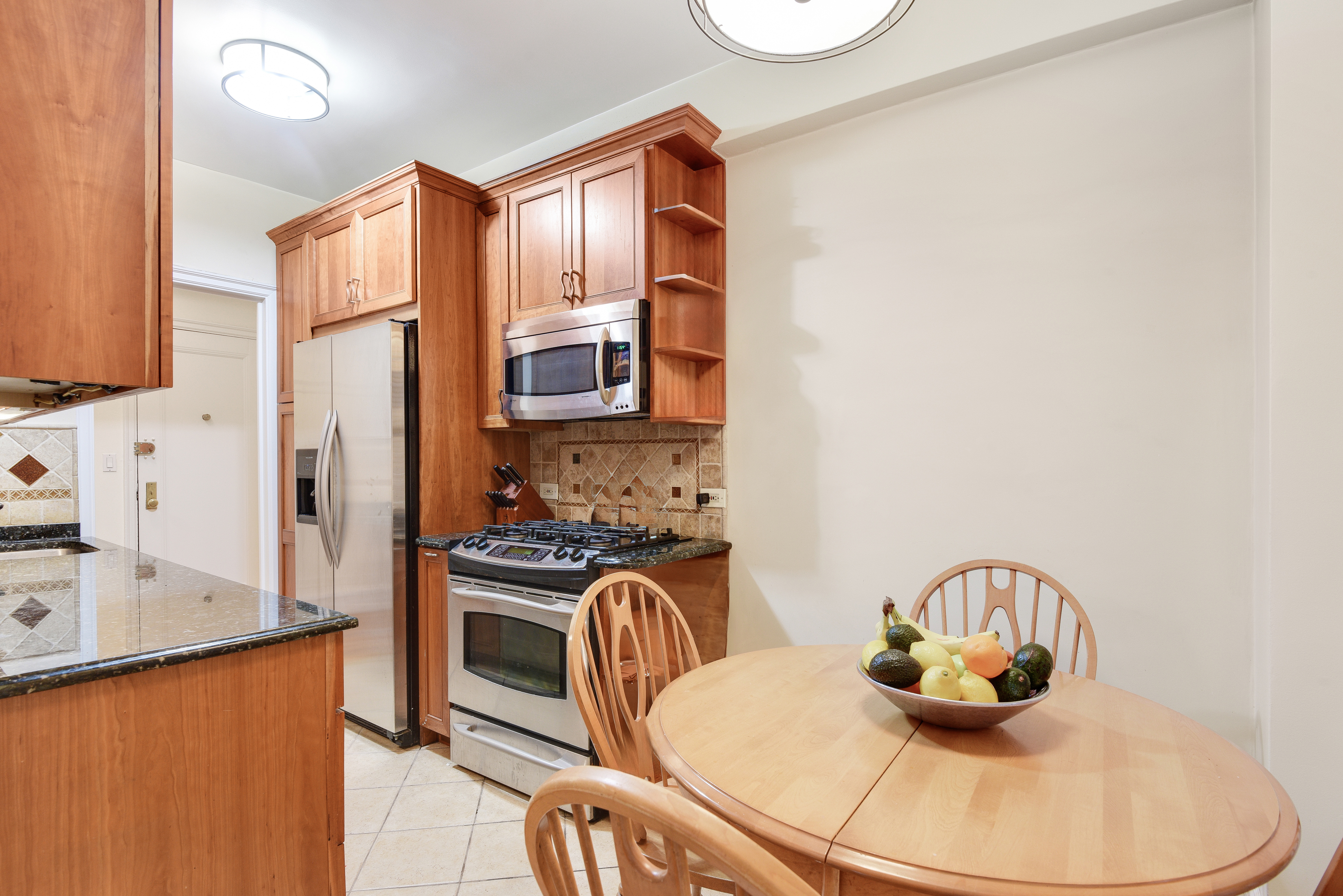 321 West 90th Street, Unit 2F/3F Manhattan, NY 10024 - Photo 6 of 15 a kitchen with stainless steel appliances granite countertop a stove a sink and a refrigerator