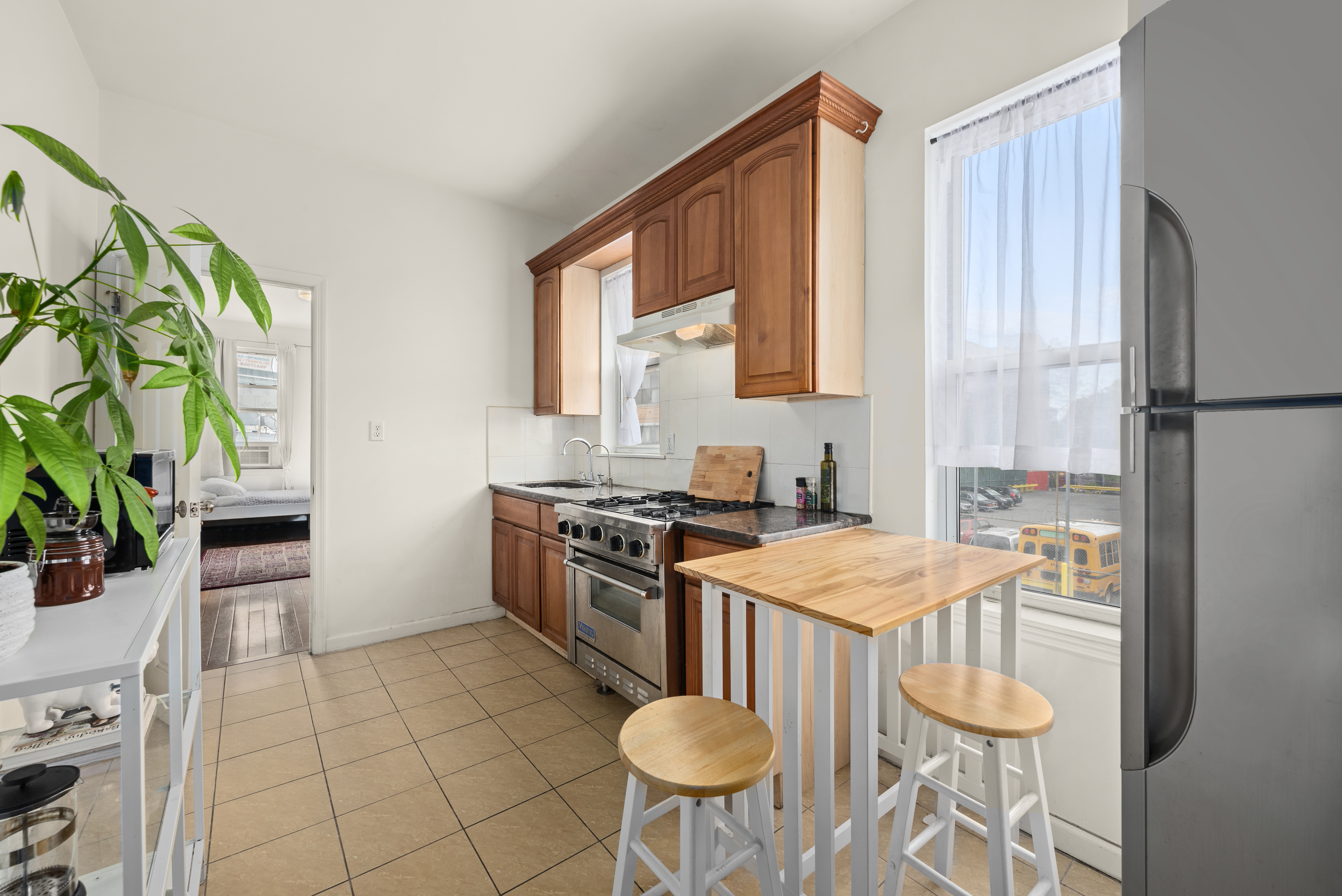 25 Bogart Street, Unit 2N Brooklyn, NY 11206 - Photo 2 of 7 a kitchen with stainless steel appliances granite countertop a stove a sink and a microwave