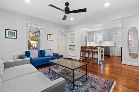 a living room with furniture and wooden floor