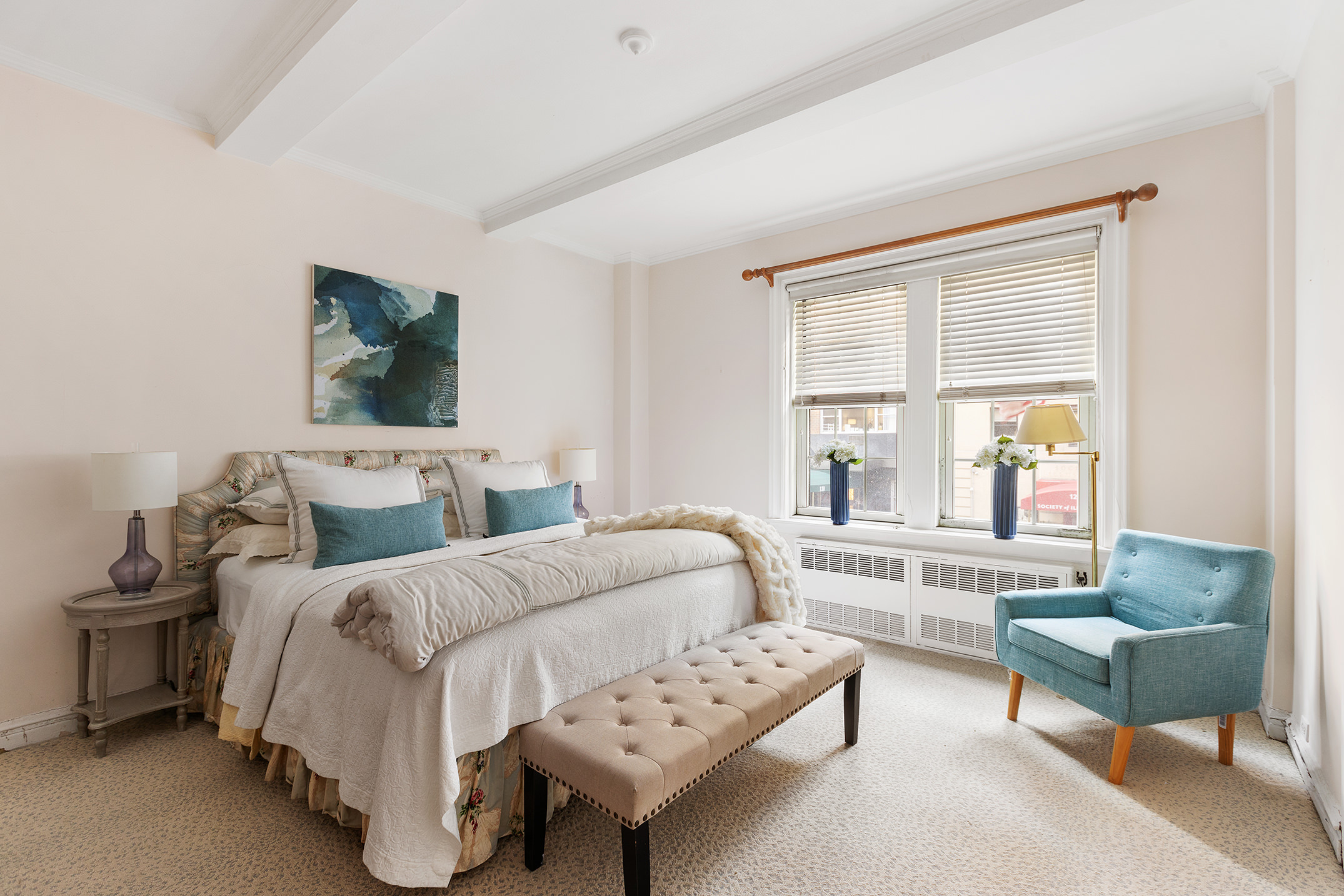 125 East 63rd Street, Unit 2B Manhattan, NY 10065 - Photo 6 of 12 a spacious bedroom with a bed and a couch