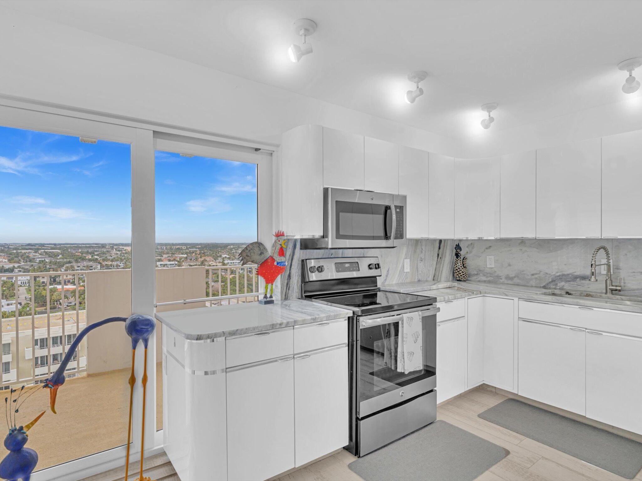 3000 South Ocean Boulevard, Unit 1504 Boca Raton, FL 33432 - Photo 13 of 64 a kitchen with a sink stove and cabinets