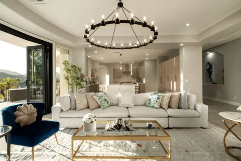 a living room with furniture and a floor to ceiling window