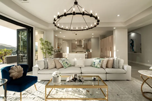 a living room with furniture and a floor to ceiling window