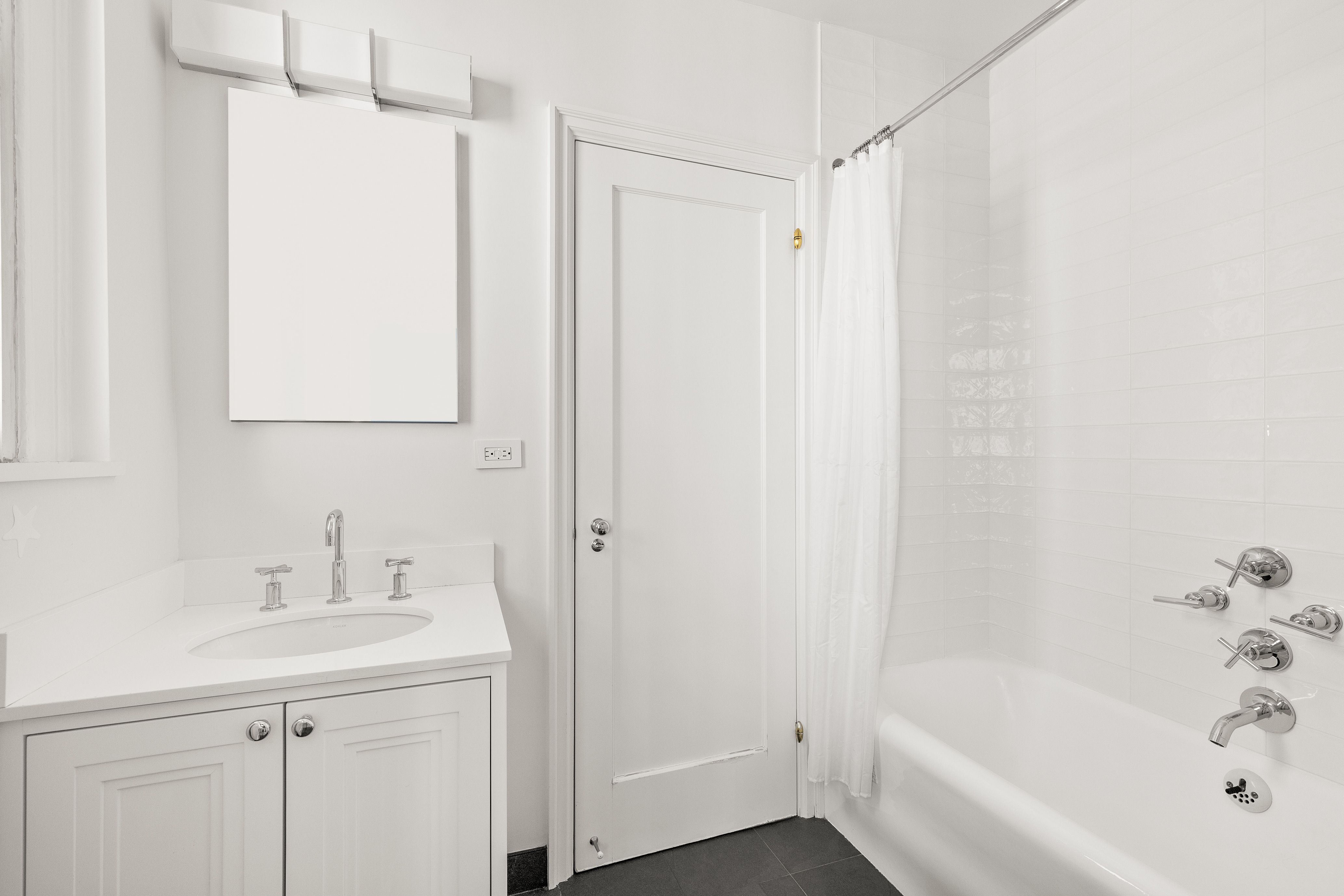 410 East 57th Street, Unit 15BE Manhattan, NY 10022 - Photo 12 of 18 a white bath tub sitting next to a white sink