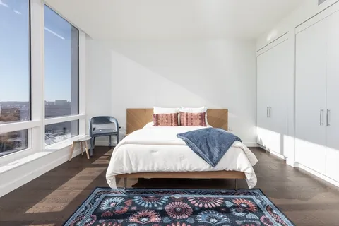 a bedroom with a bed and wooden floor