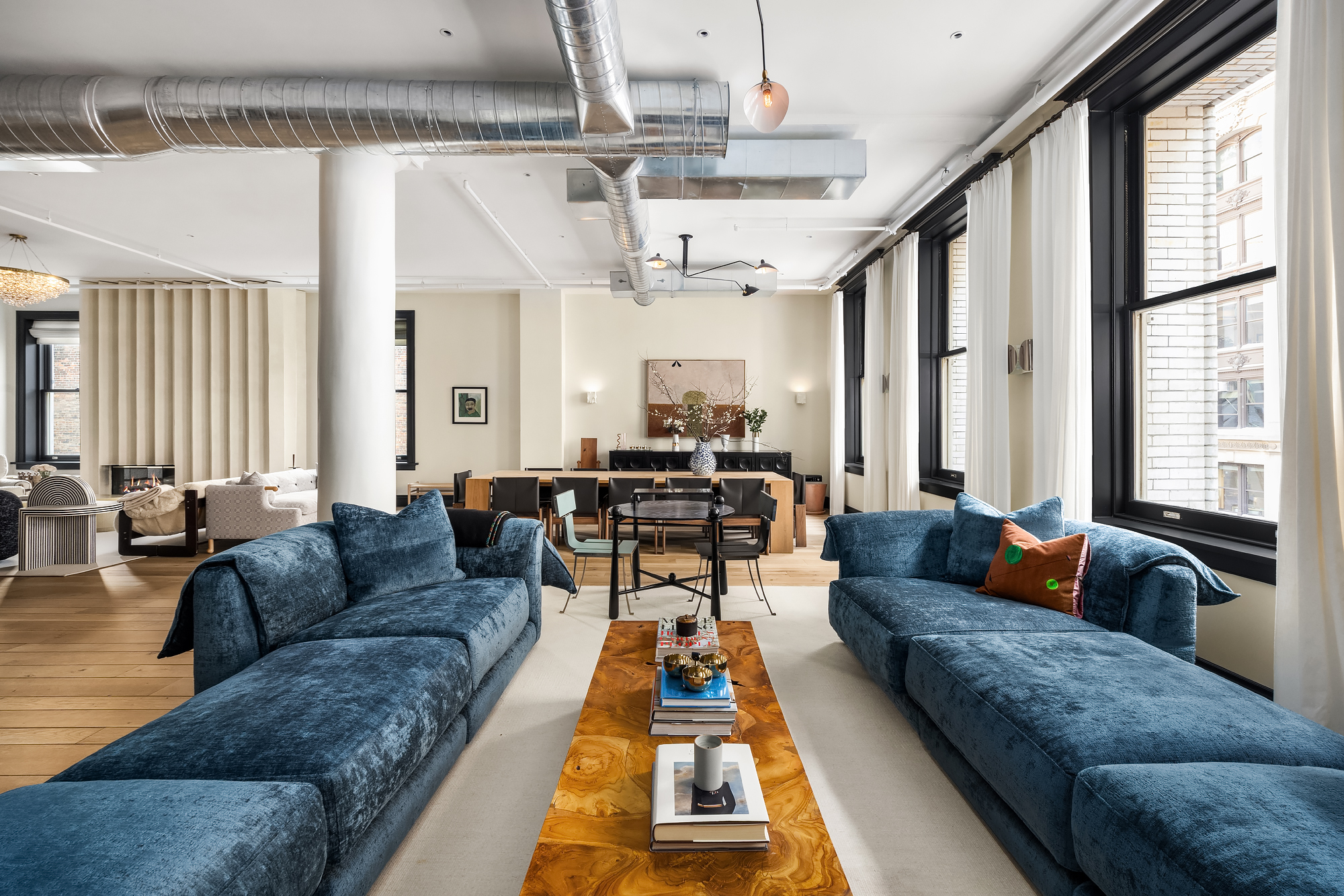 158 Mercer Street, Unit 6B Manhattan, NY 10012 - Photo 2 of 16 a living room with furniture and a large window