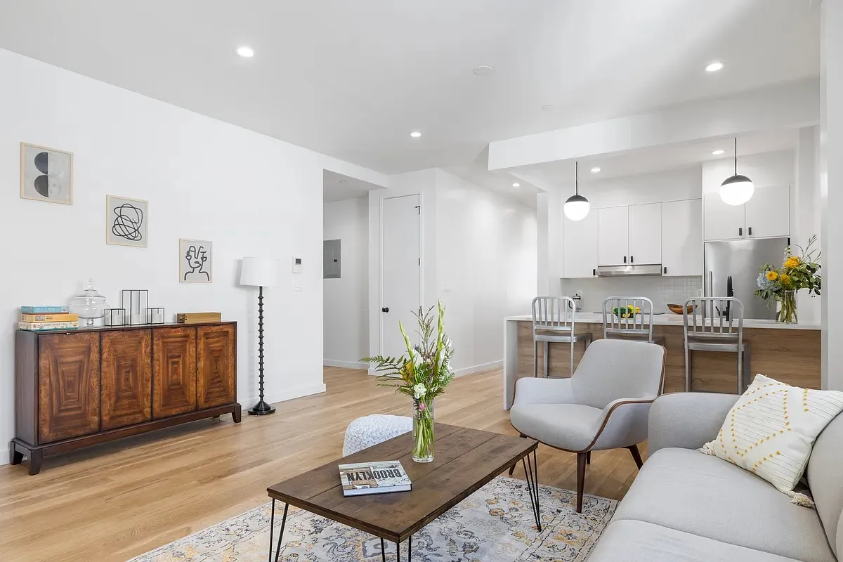 a living room with kitchen island furniture and a kitchen view