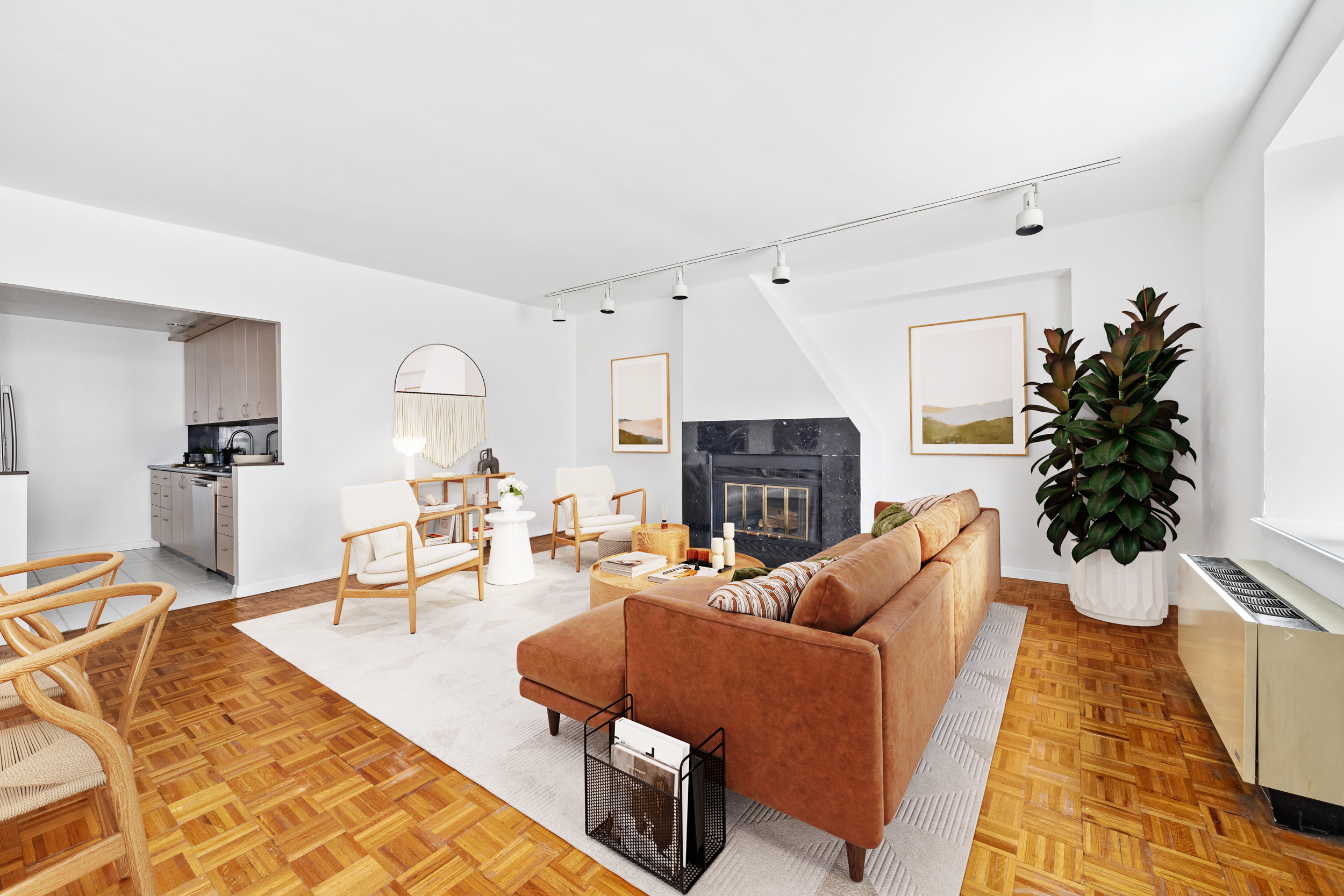 196 6th Avenue, Unit 5A Manhattan, NY 10013 - Photo 2 of 12 a living room with furniture a fireplace and a potted plant