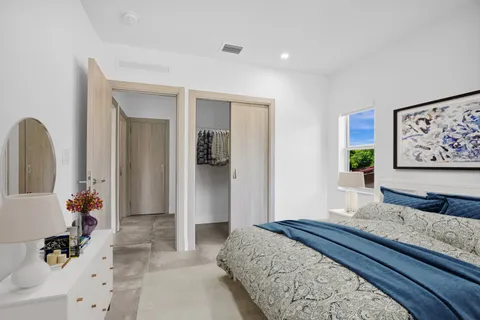a bedroom with a large bed and a dresser