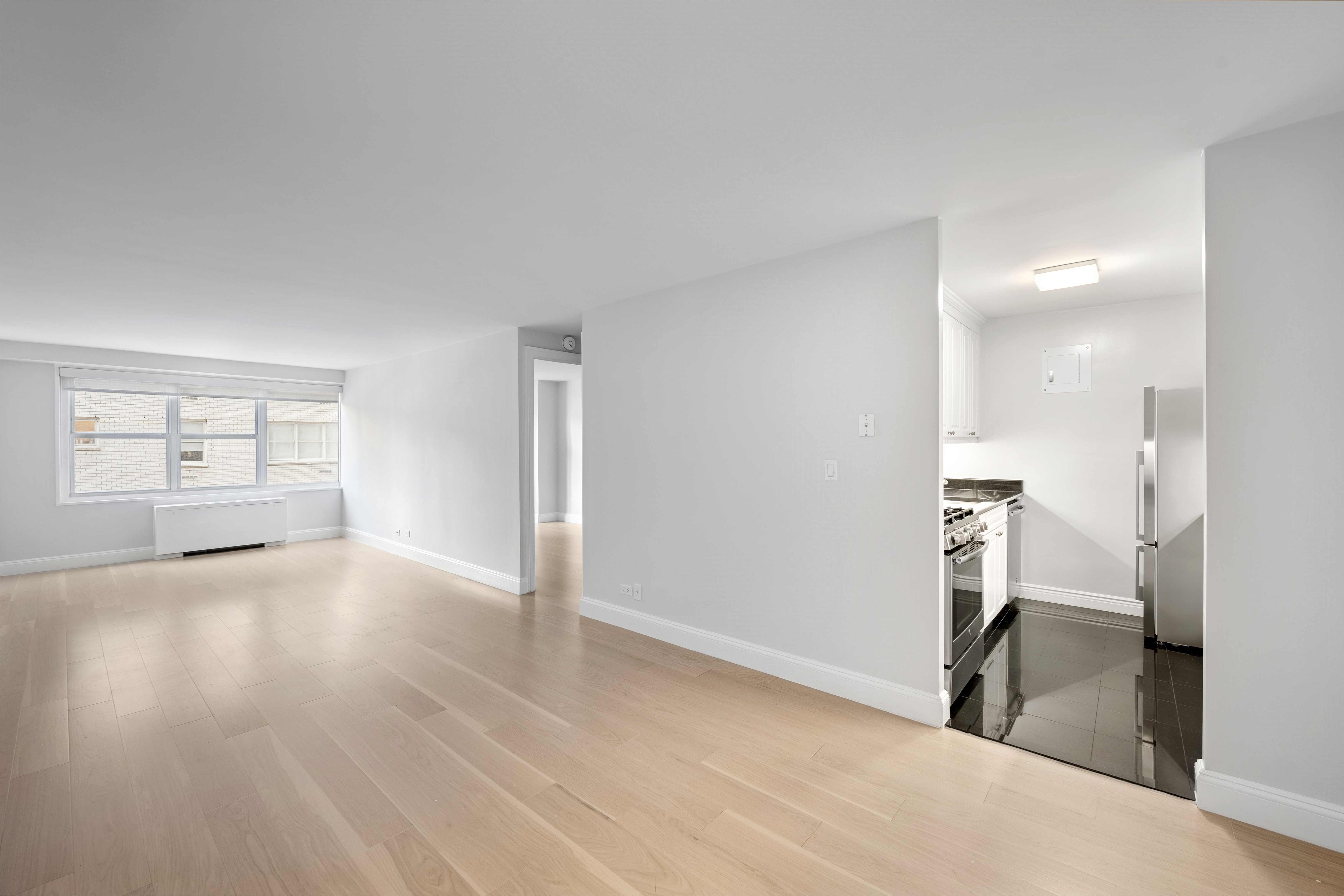 155 West 68th Street, Unit 815 Manhattan, NY 10023 - Photo 6 of 14 a view of empty room with wooden floor