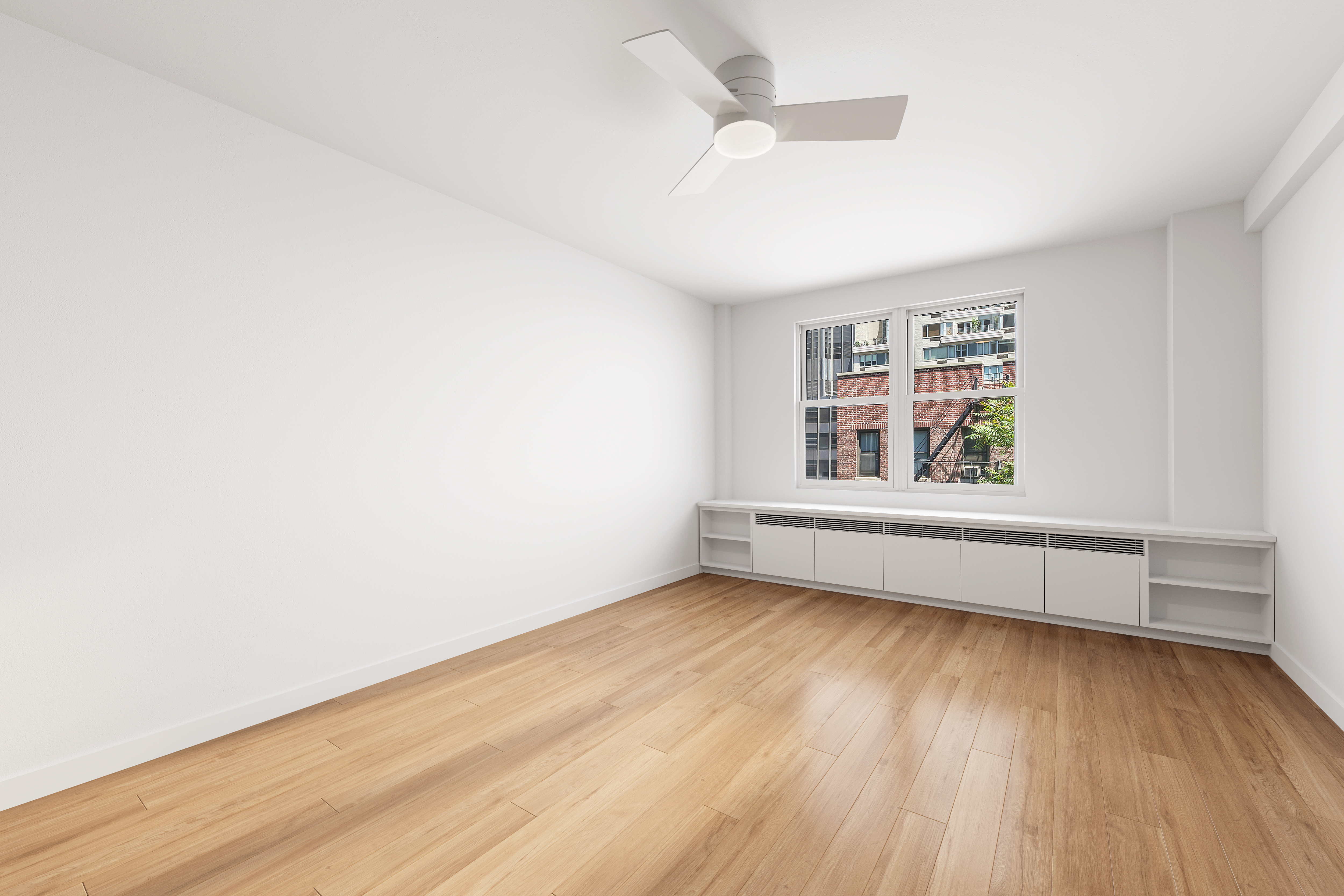 221 East 50th Street, Unit 6D/7D Manhattan, NY 10022 - Photo 14 of 19 an empty room with wooden floor and windows