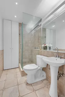 a bathroom with a sink toilet and shower