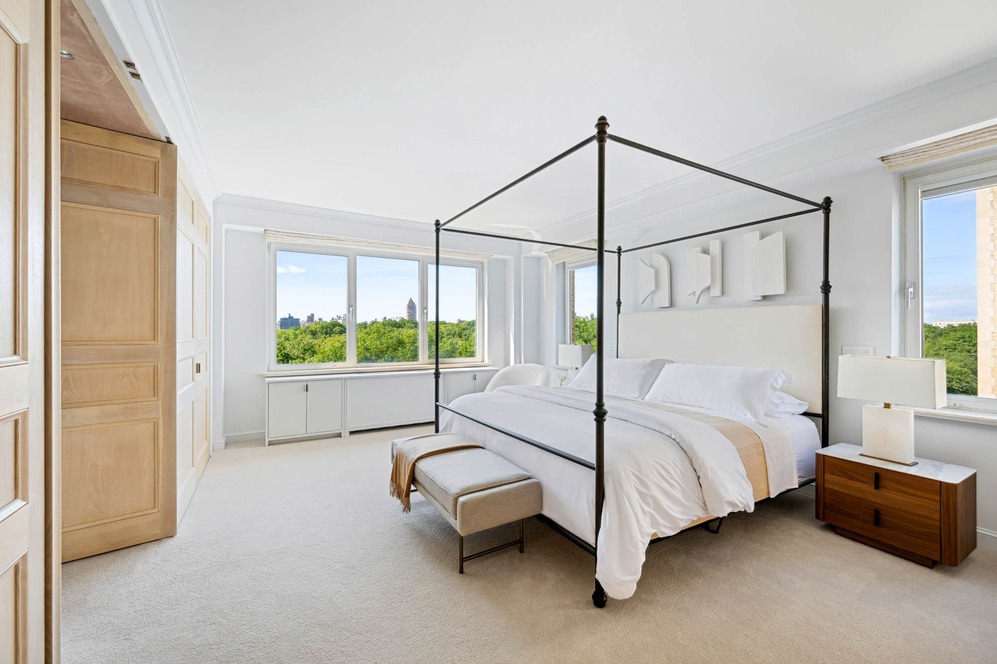 936 5th Avenue, Unit 10AB Manhattan, NY 10021 - Photo 14 of 37 a bed sitting in a spacious bedroom next to a window