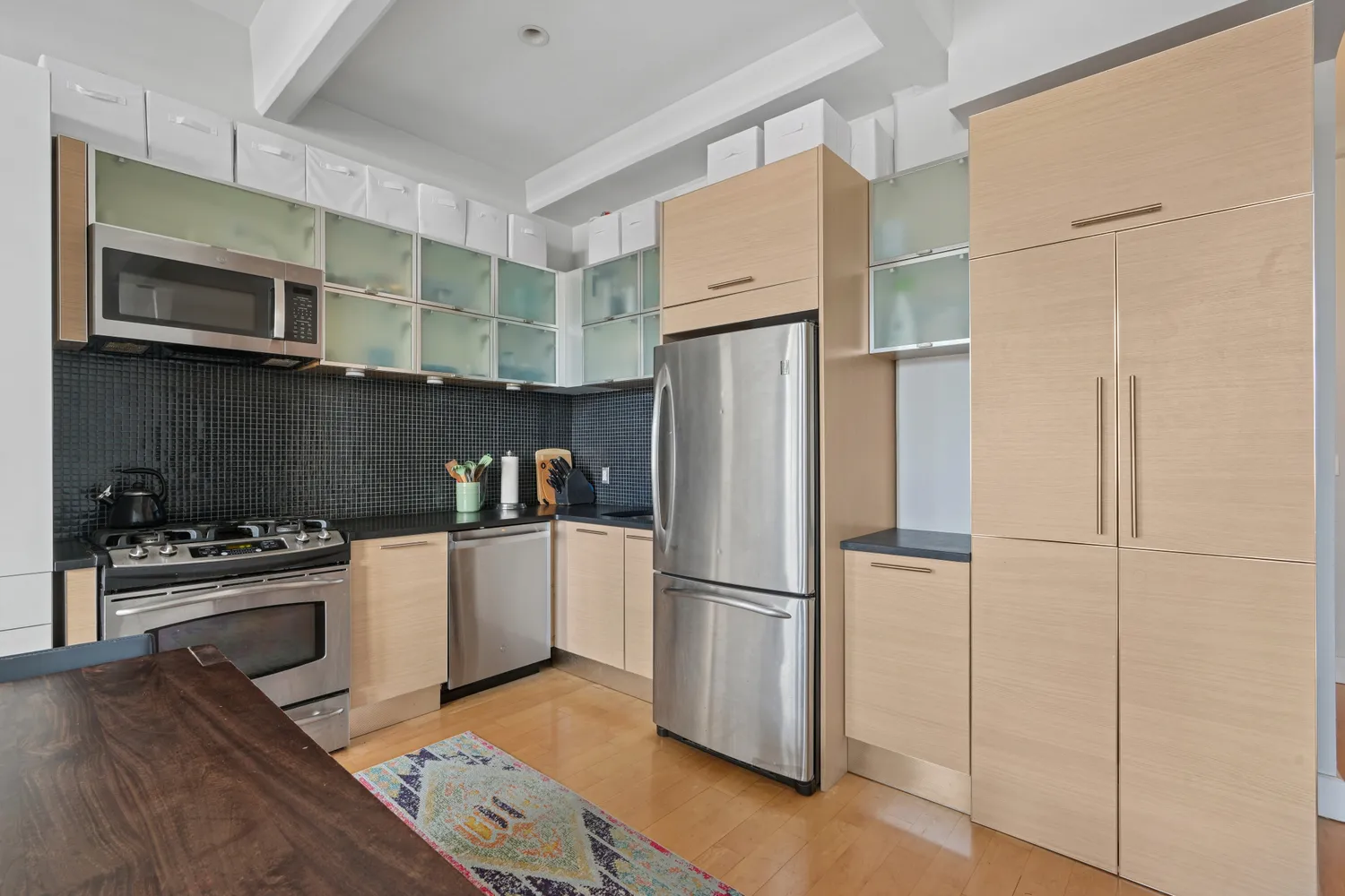 a kitchen with stainless steel appliances a refrigerator stove and sink