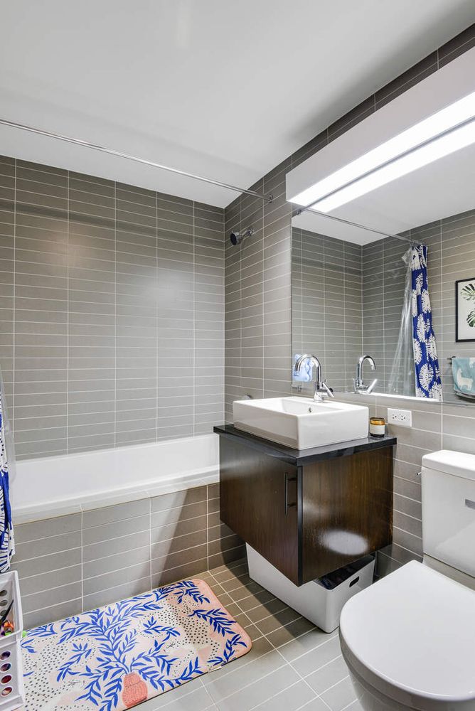 150 Myrtle Avenue, Unit PH3201 Brooklyn, NY 11201 - Photo 18 of 40 a bathroom with a sink mirror vanity and toilet