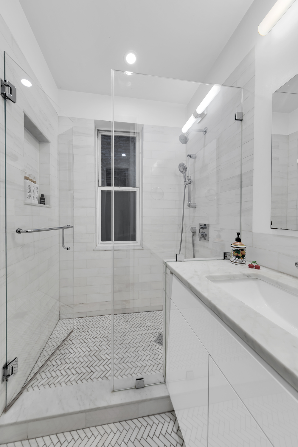 323 West 11th Street, Unit 2WE Manhattan, NY 10014 - Photo 7 of 11 a bathroom with a sink and mirror