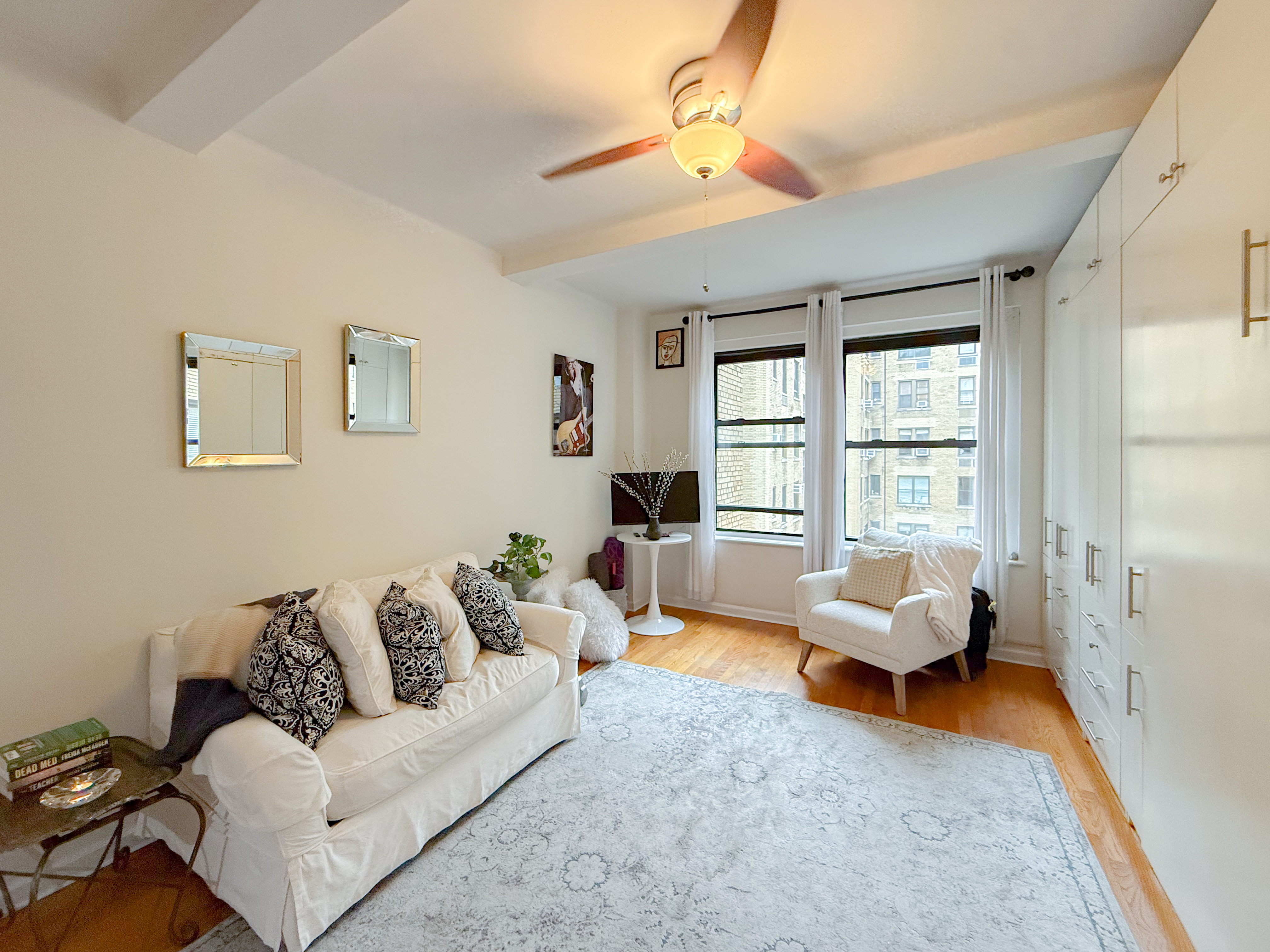 230 Central Park West, Unit 14I Manhattan, NY 10024 - Photo 1 of 17 a living room with furniture and a large window