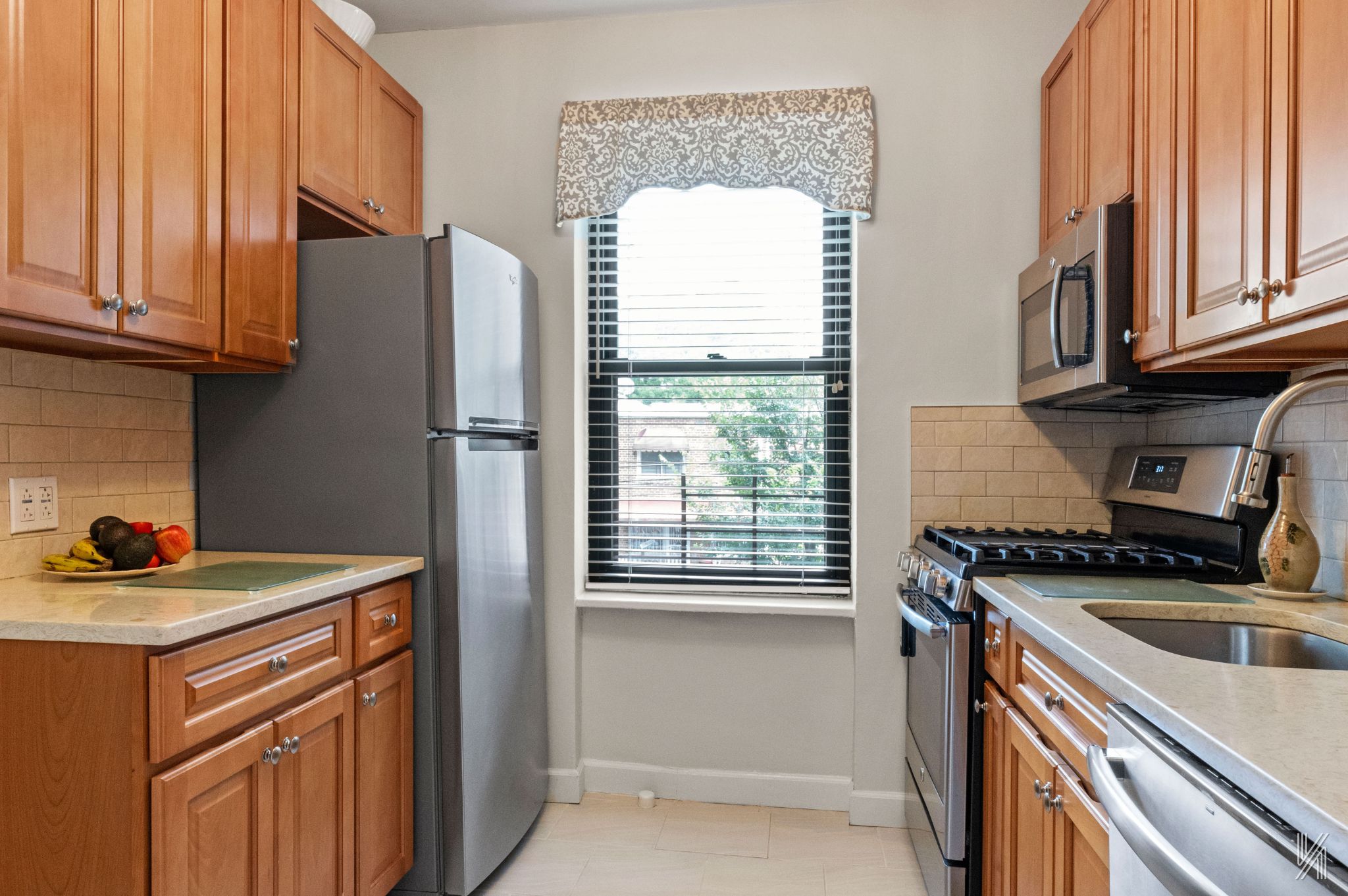 22-08 76th Street, Unit D2 Queens, NY 11370 - Photo 12 of 20 a kitchen with stainless steel appliances granite countertop a refrigerator and a sink