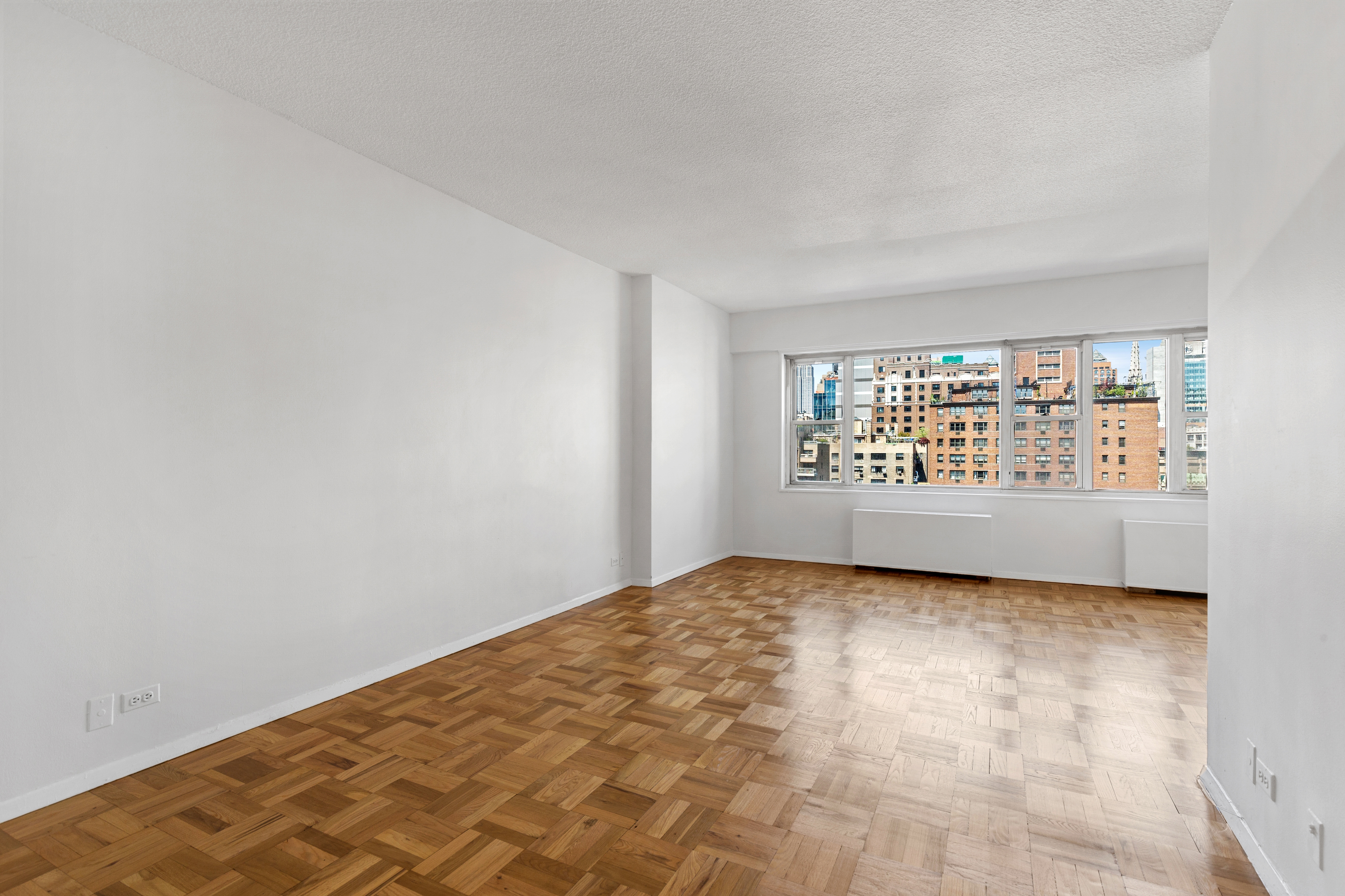 60 East 8th Street, Unit 9J Manhattan, NY 10003 - Photo 2 of 13 a view of an empty room with a window