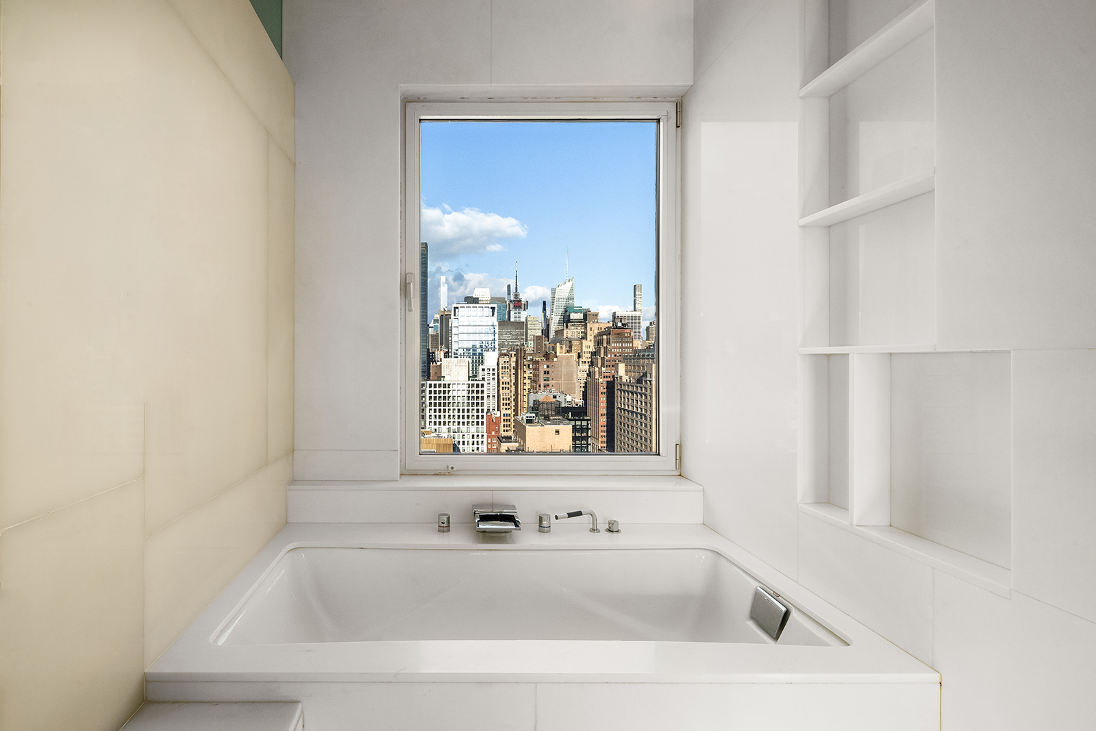 252 7th Avenue, Unit PHD Manhattan, NY 10001 - Photo 10 of 26 a bathroom with bathtub and window