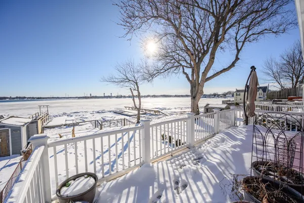 a view of a balcony with wooden floor and fence