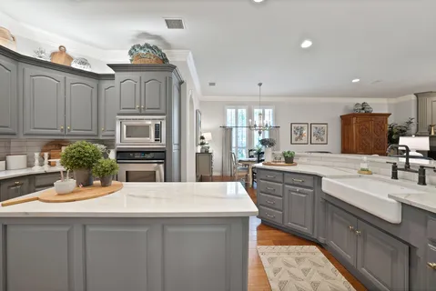 a kitchen with sink cabinets and living room